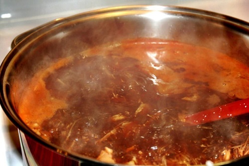 Cocción pozole Maíz y carne de cerdo hirviendo en una olla, un paso esencial en la preparación del pozole.