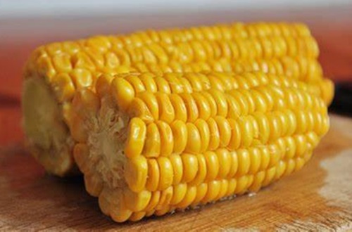 Elotes dulces Trozos de elote dulce cocidos y amarillos, integrados con la mantequilla especiada y los camarones.